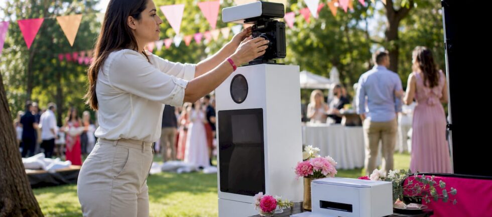 Event planner arranging photo booth equipment