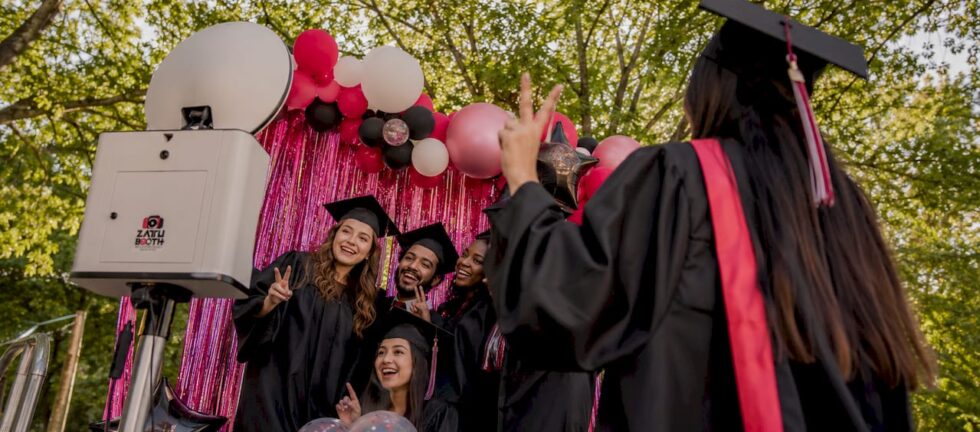 Graduates posing at photo booth during celebration