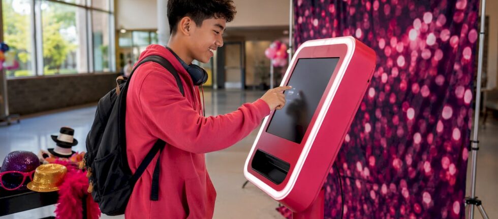 Student interacting with school photo booth