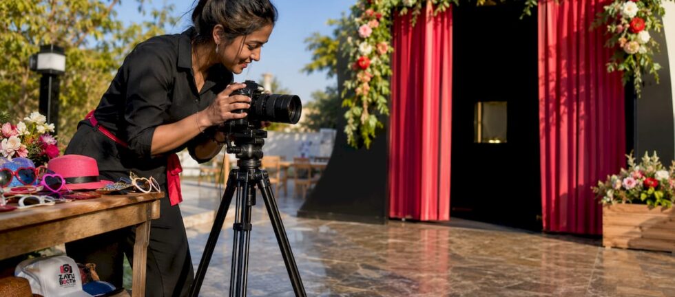 Premium wedding photo booth with operator adjusting camera