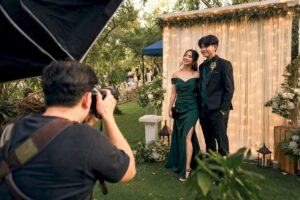 Photographer adjusting softbox lighting for prom couple photo
