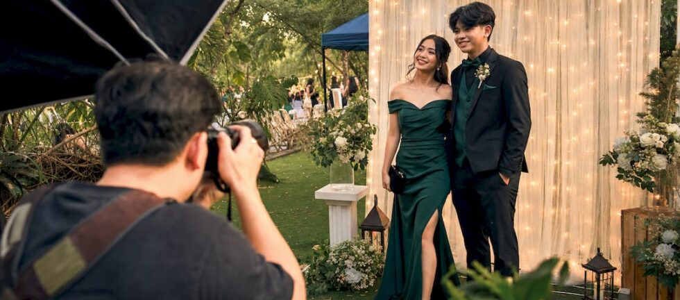 Photographer adjusting softbox lighting for prom couple photo